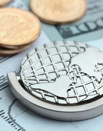 Coins, paper money and globe on white Statistic form background