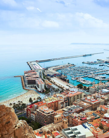 Top view of Port  in Alicante with docked yachts from castle. Spain